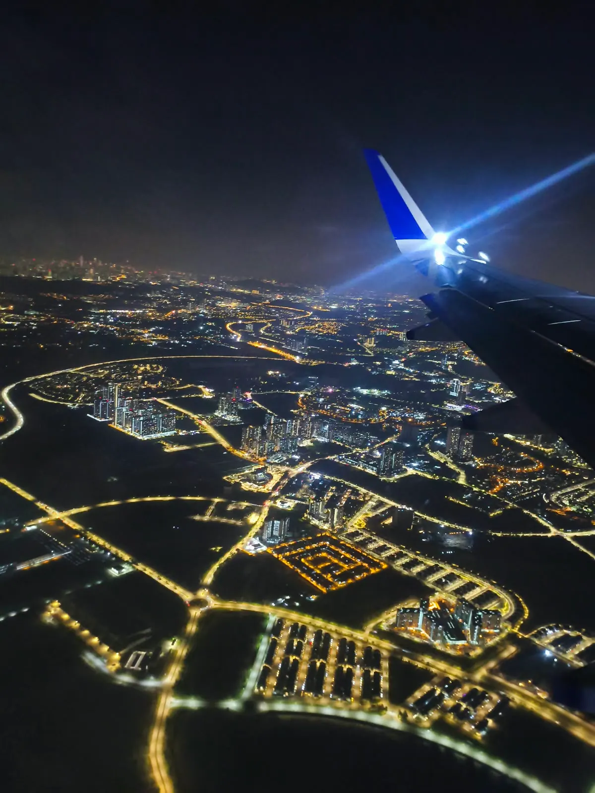 Kuala Lumpur city lights seen from an airplane window at night
