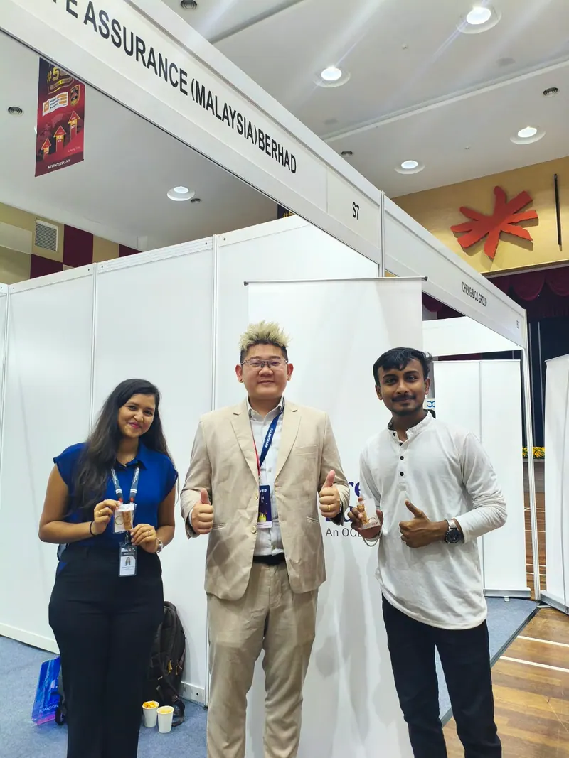 Prathamesh Halale with an industry professional at an employer booth in the INTI event hall, Malaysia