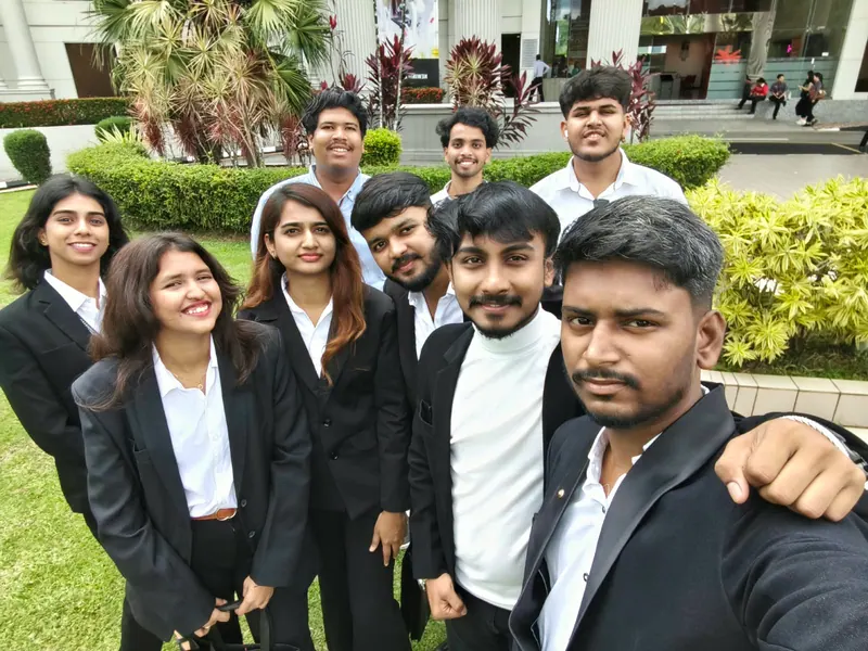 Prathamesh Halale with fellow international students in formal wear at INTI International University, Malaysia