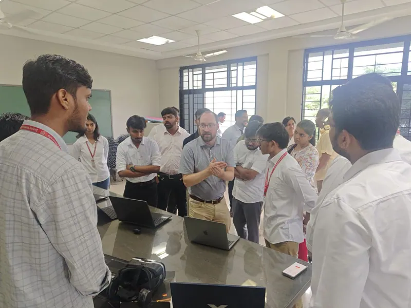 Discussion with David Curran about NextIn's technology, with laptops and a VR headset on the demo table