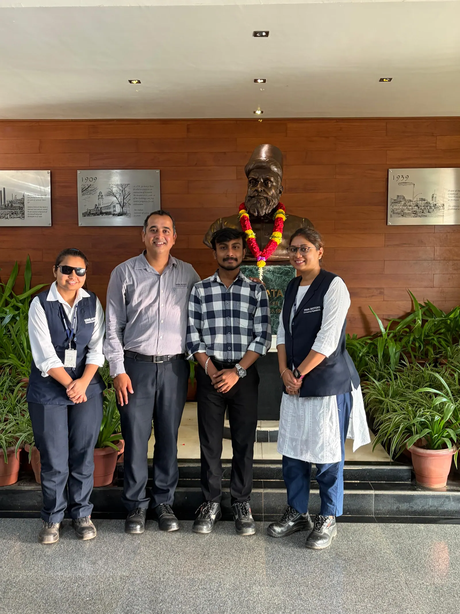 Prathamesh Halale with Tata Motors colleagues beside the bust of Tata Group founder Jamsetji Tata at Tata Motors, Dharwad
